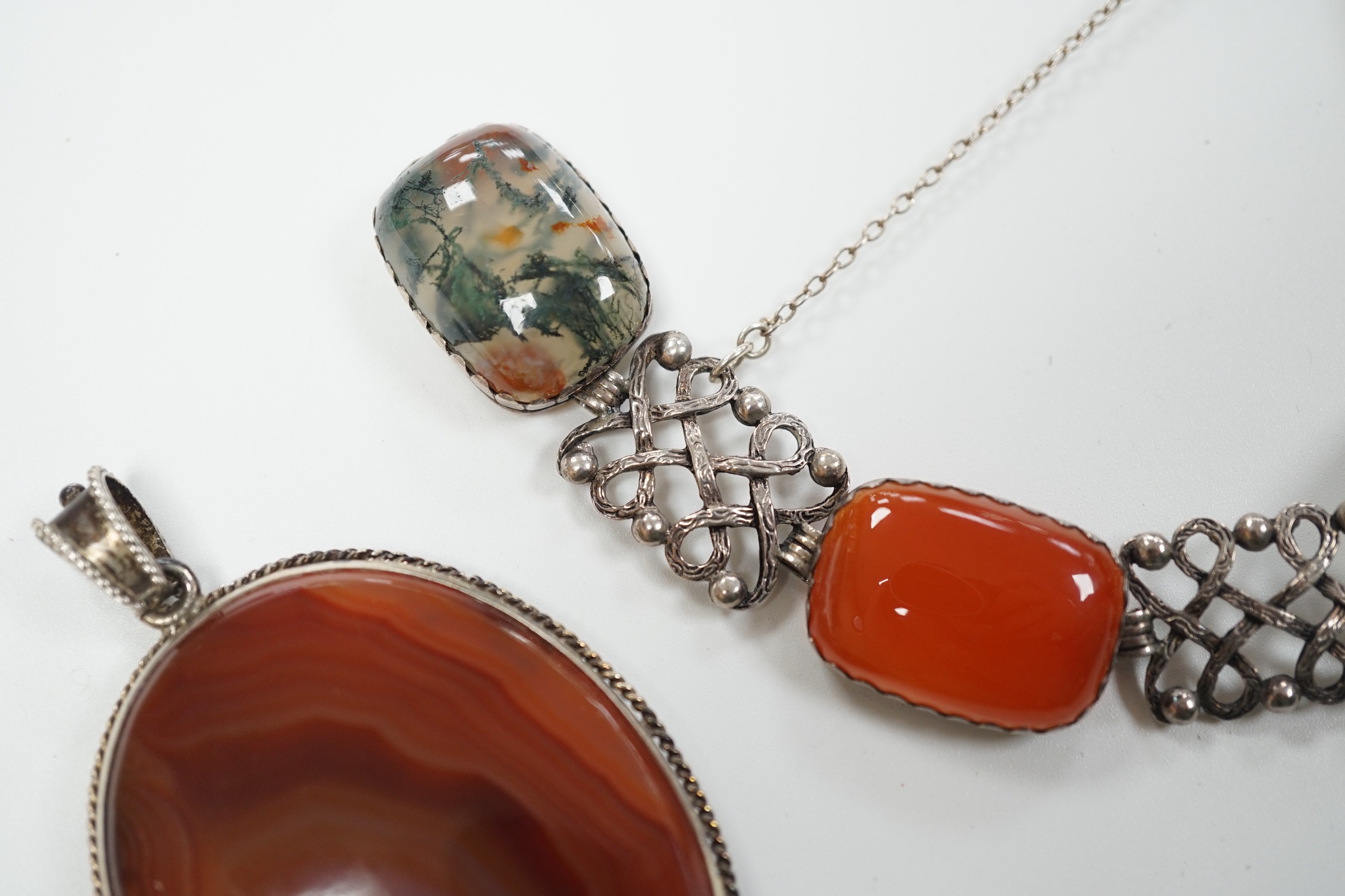 A pierced white metal and four stone agate set bracelet, 18.5cm and a white metal and banded agate set oval pendant.